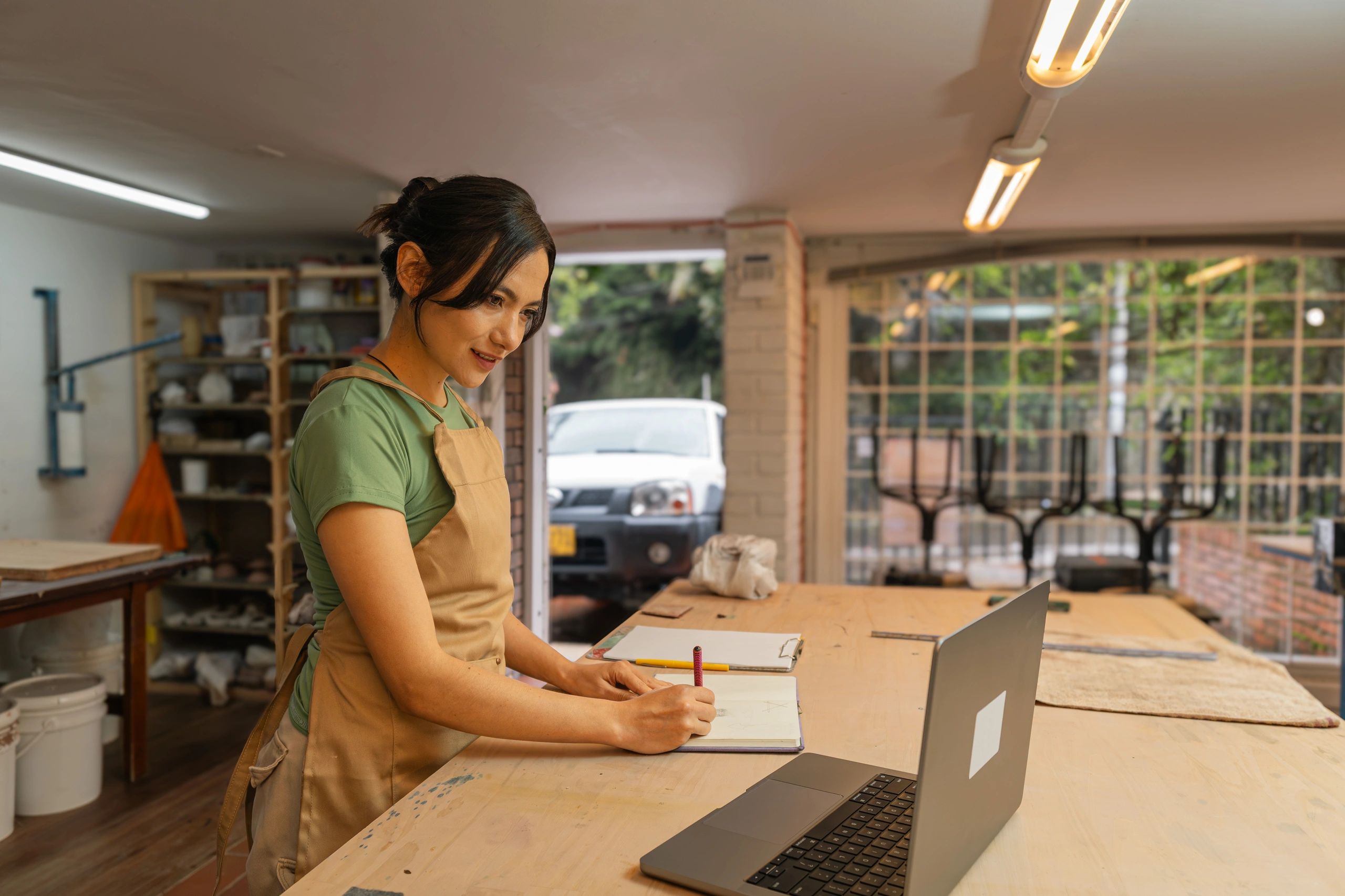 Small business owner planning at a laptop